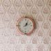 retro oink clock on a vintage style wallpapered wall